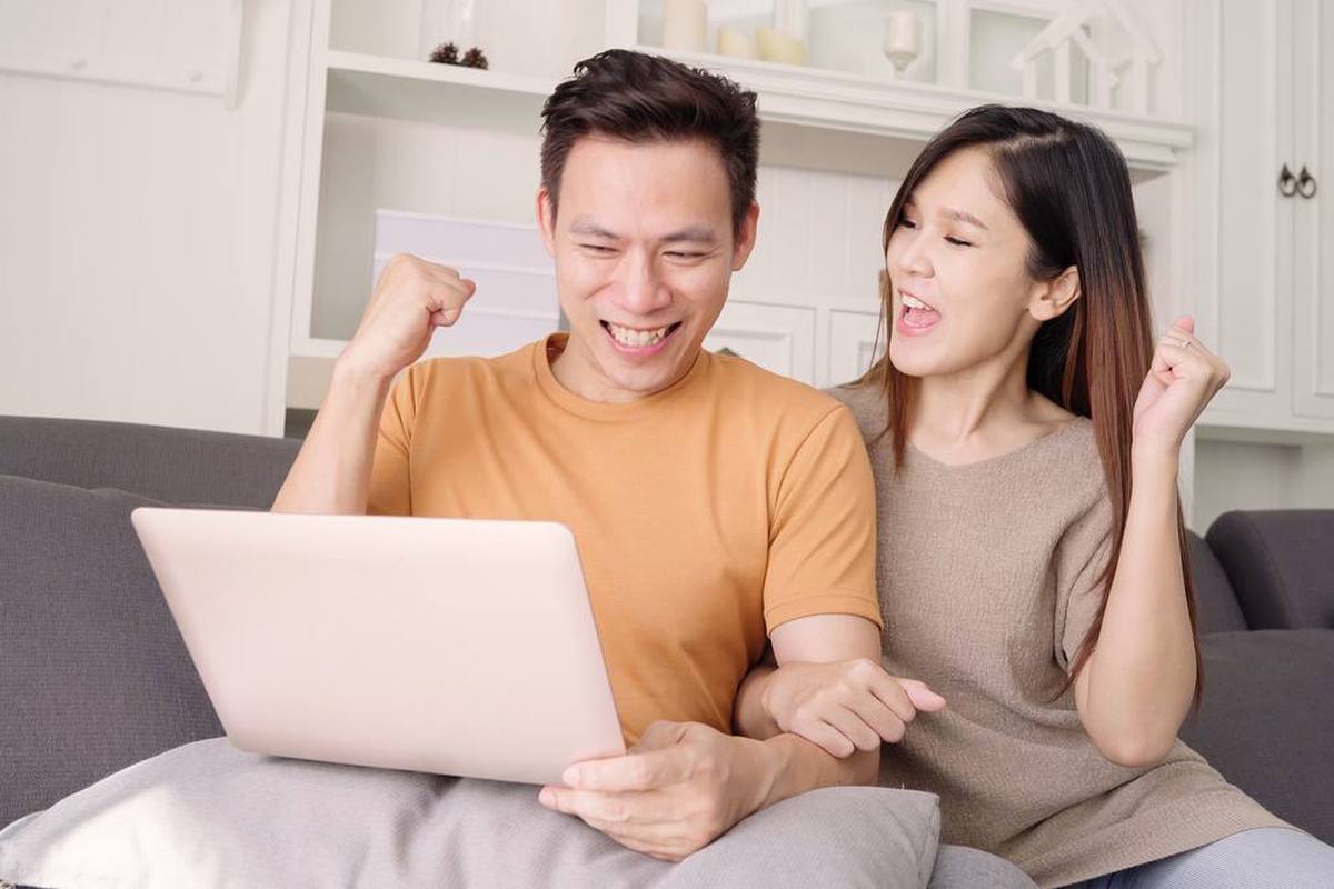 A couple searching for services online at home