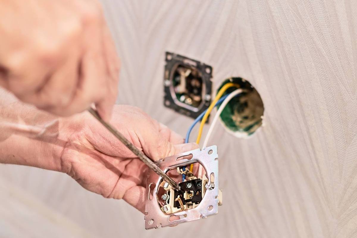 Electrician wiring a power socket