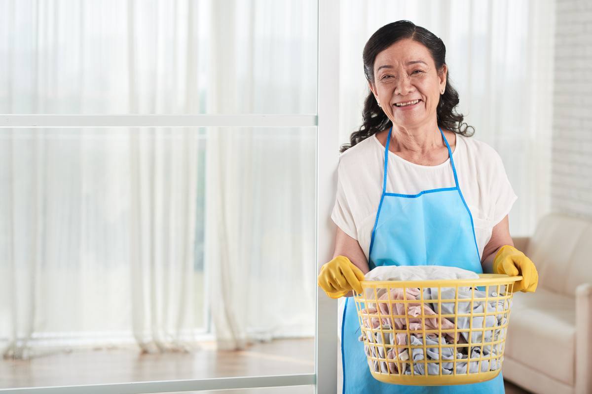 Domestic helper holding a laundry basket