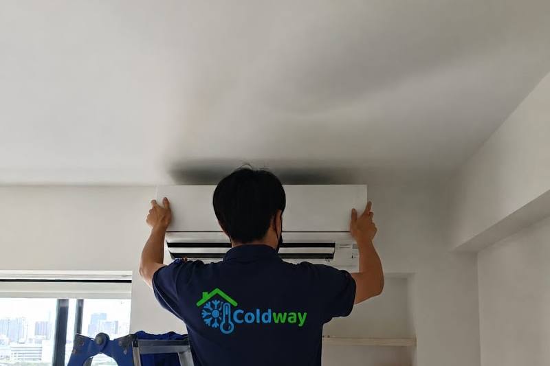Technician fitting a wall-mounted aircon unit by Coldway