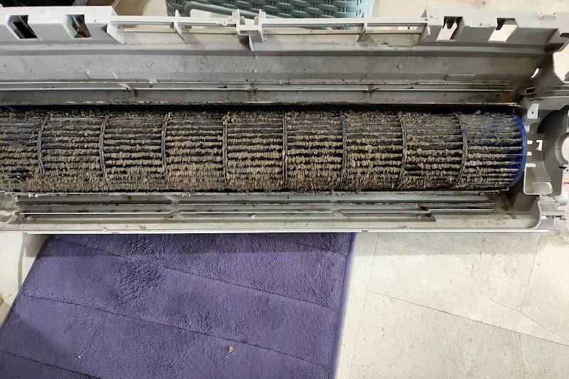 A dirty blower wheel inside an opened aircon unit by GoodCool Aircon