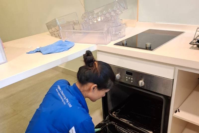 Cleaner cleaning an oven by Axgee Cleaning