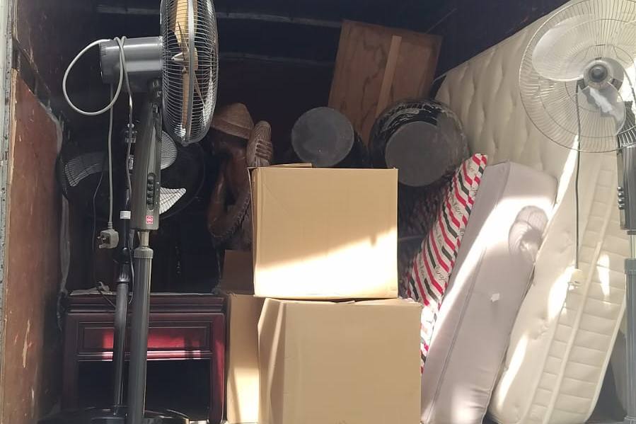 Fans, boxes and a mattress loaded in a lorry by Disposal Service Singapore