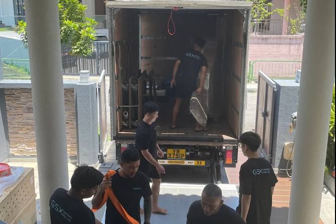 Crew loading a lorry outside a house for GSX Moving