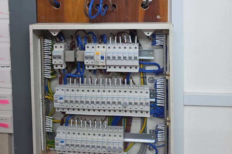 Newly wired distribution board with rows of circuit breakers by Xpower Electrical