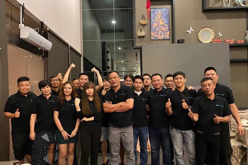 Team photo of staff in company shirts by LS Handyman Service