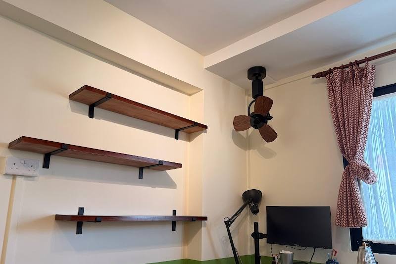 Wall shelves and a ceiling fan fitted in a room by Profix Handyman Services Singapore