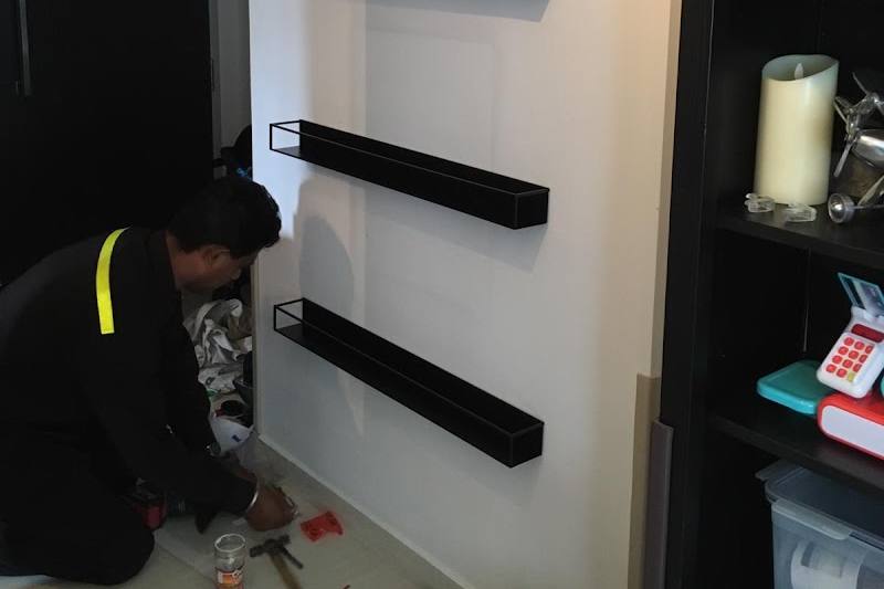 Wall shelves being fitted in a flat by Superstar Handyman Singapore