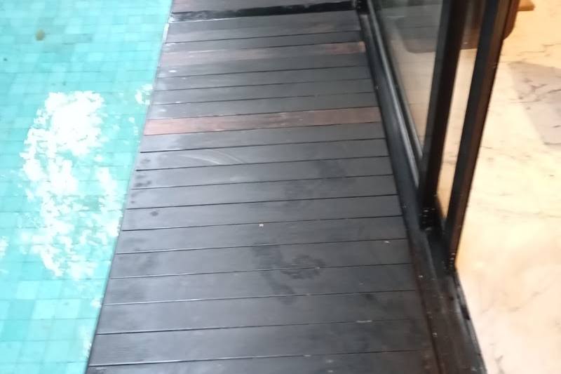 Timber decking beside a swimming pool by Tasfia Handyman Service