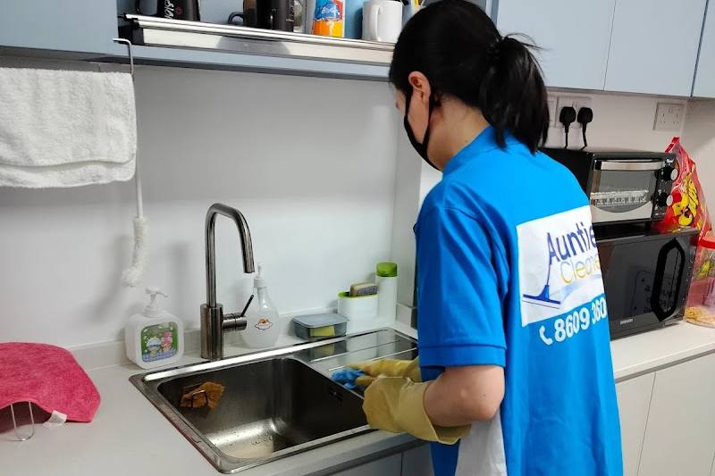 A cleaner washing up at a kitchen sink by Auntie Cleaner