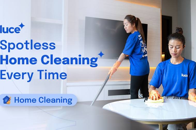 Two cleaners wiping a table and mopping a living room by Luce