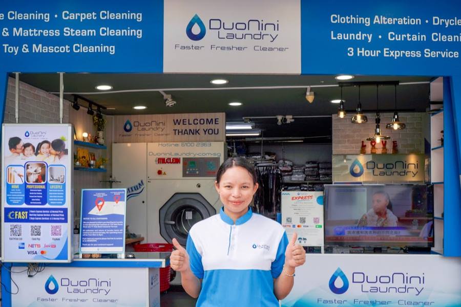 Staff member at the Telok Kurau laundry counter by Duo Nini