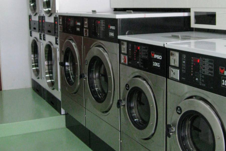 Row of self-service washing machines by LaundryMart Express