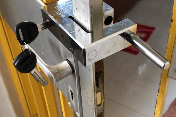 A lever lockset fitted on a yellow metal gate by Ace Locksmith Singapore