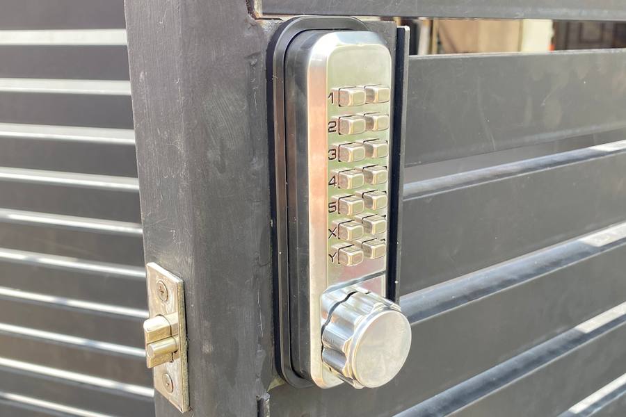 A push-button code lock fitted on a metal gate by ASSIST Locksmith Singapore