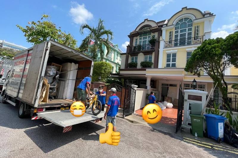 Movers unloading a truck outside a house by Yong Shen Movers