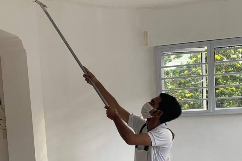 Painter rolling paint onto a ceiling by Meptech Painting Services