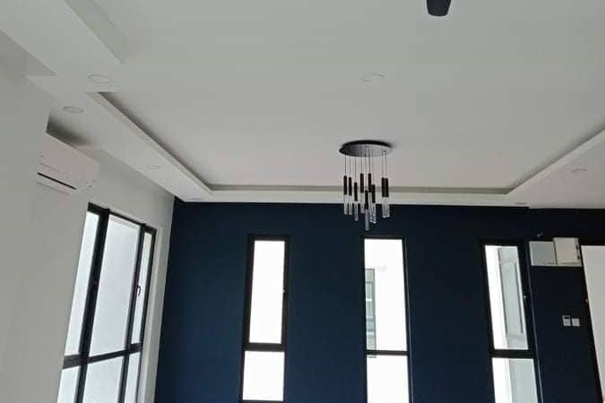 Freshly painted condo room with a dark blue feature wall by PS Painting Service Singapore
