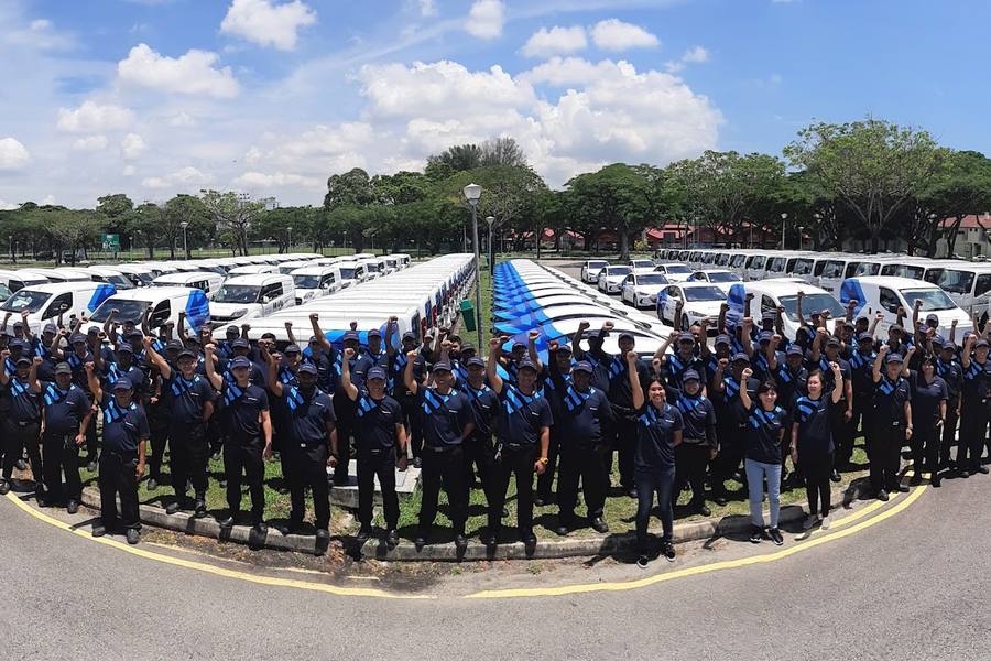 Staff group photo in front of the company's van fleet by Anticimex