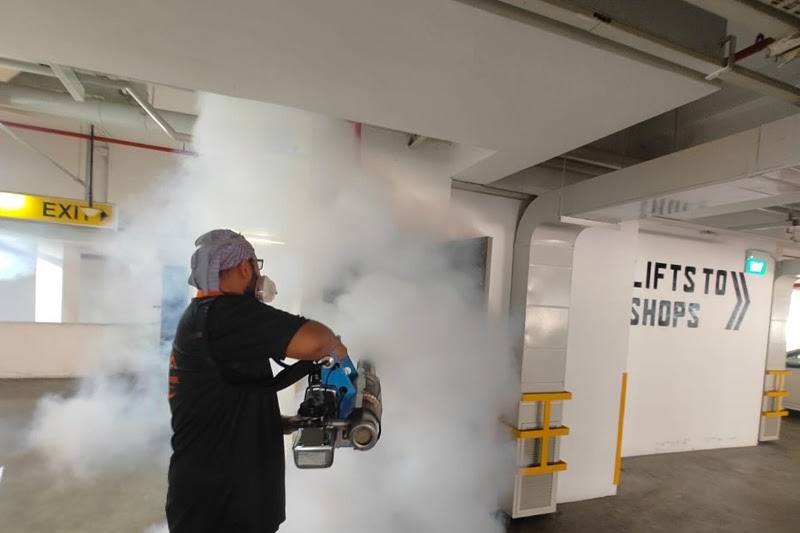 Technician fogging a car park by Ironman Pest Control