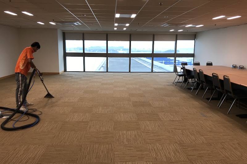Technician deep-cleaning an office carpet by Art of Cleaning