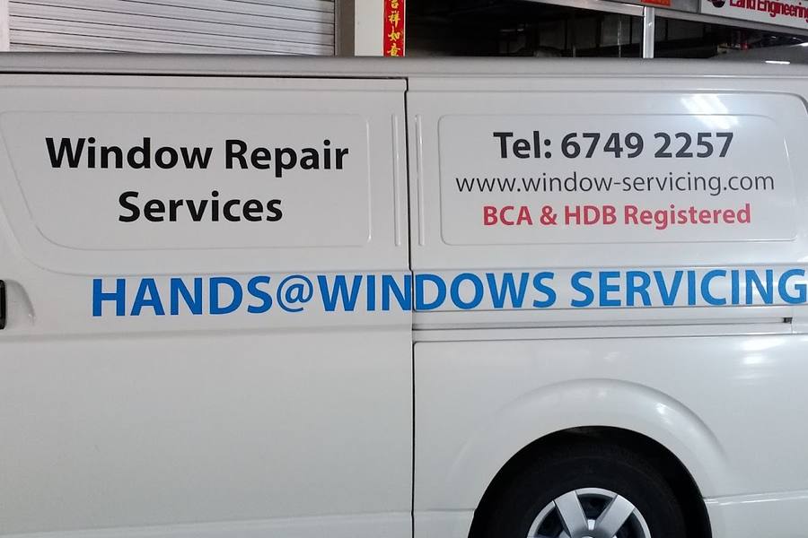Company van with window repair signage by Hands@Windows Servicing