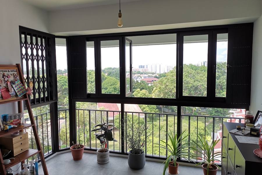 Black-framed windows fitted around a flat's balcony by Ziam Gei Huat Aluminium